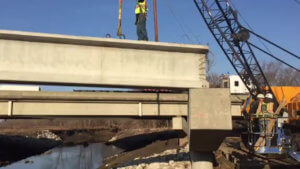 Beams are place atop the Warren County Bridge span.