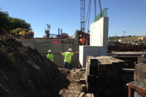 Crew members work along concrete slabs.