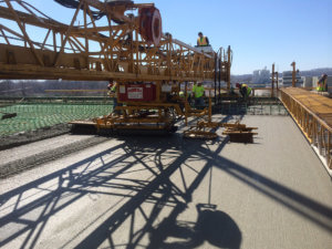 Concrete finishing is performed on the Middle River bridge.