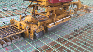 Concrete finishing equipment is prepared for use.
