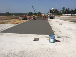 Workers pour cement on a Warren County road.